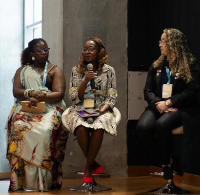 Three women speakers on stage