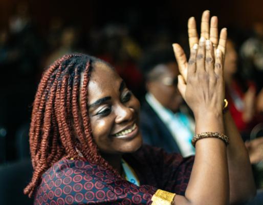 Audience member smiling and clapping