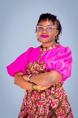 Black woman in pink outfit posing for portrait photo