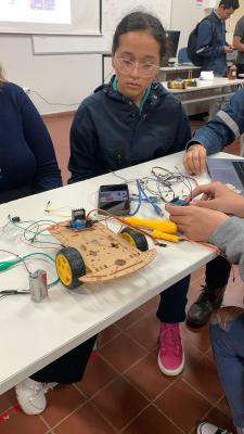Girl taking part in electronics experiment at an OWSD Bolivia outreach day