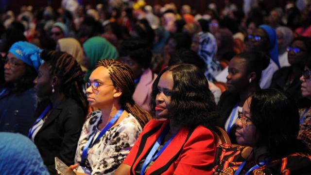 Diverse women in a conference audience