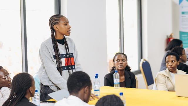 Young woman addresses a class