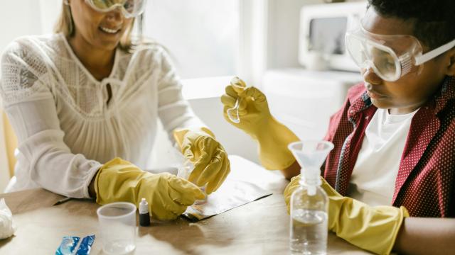 Mother scientist from the Global South making experiments with a child