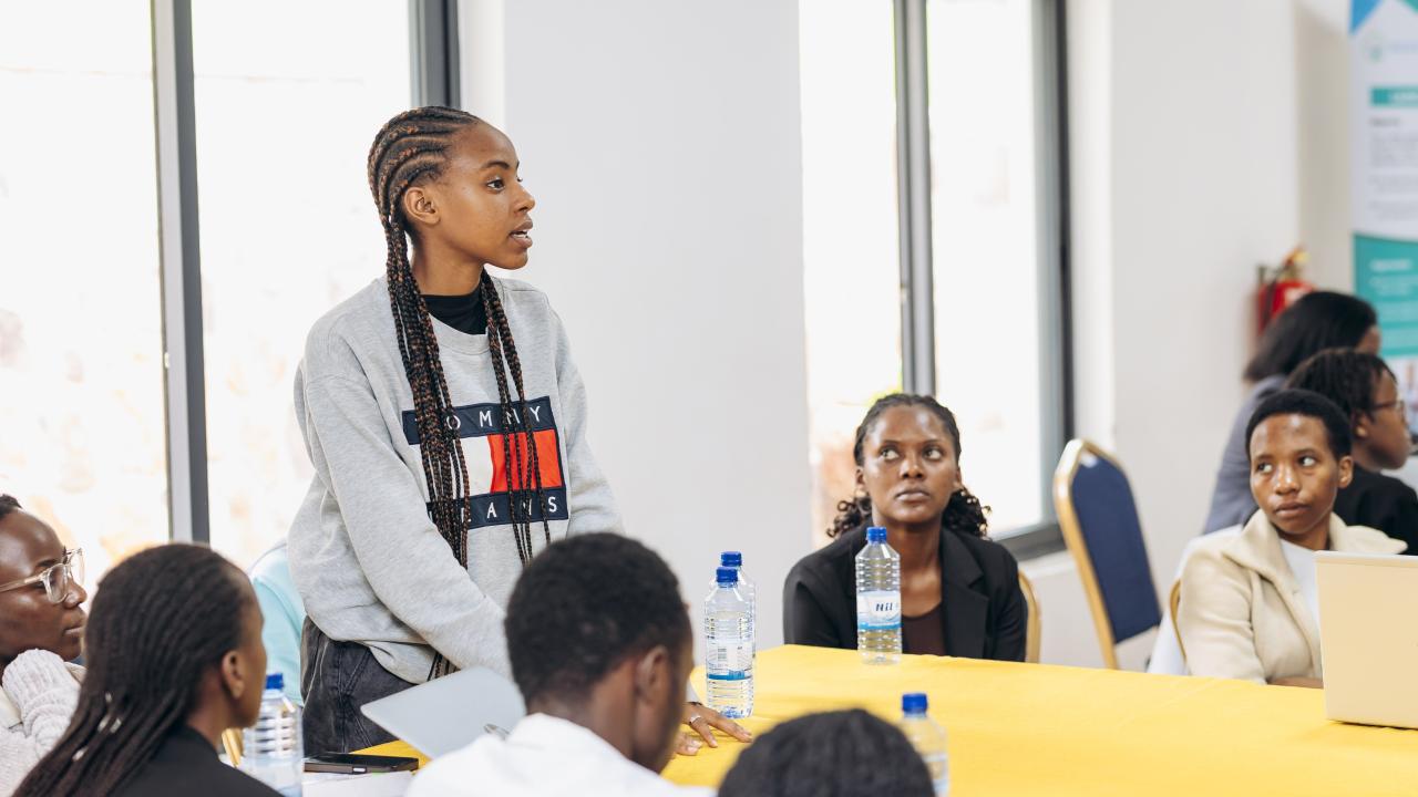 Young woman addresses a class