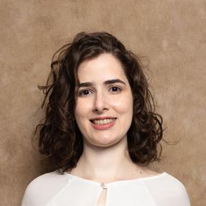“Professional Portrait of a woman facing the camera, dressed in business attire.