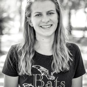 Photo of a blonde female scientist wearing a tshirt with bats on