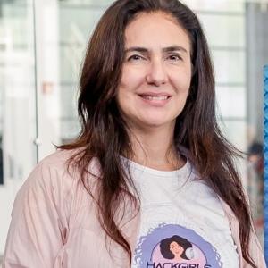 Middle-aged Latina woman, fair-skinned, with long black hair.