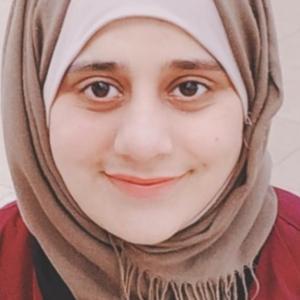 A muslim woman with black eyes and headscarf.