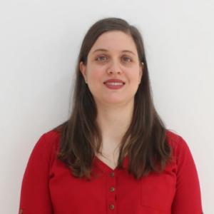 Professional portrait of a female researcher wearing business attire, suitable for an academic profile