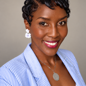 Professional portrait of biochemist Dona Mwiria wearing a blue blazer.