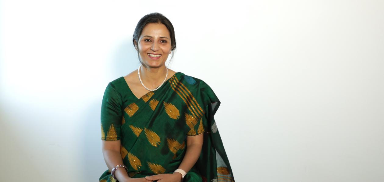 Woman in sari, posing for studio photo