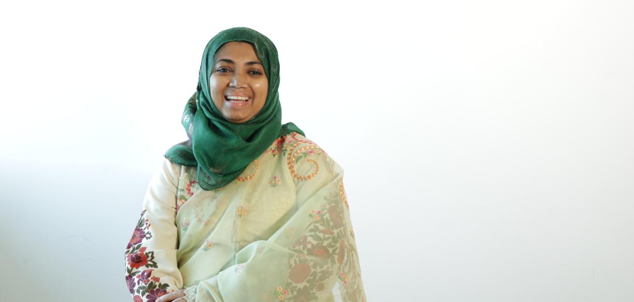 Woman in headscarf poses for photo in a studio environment